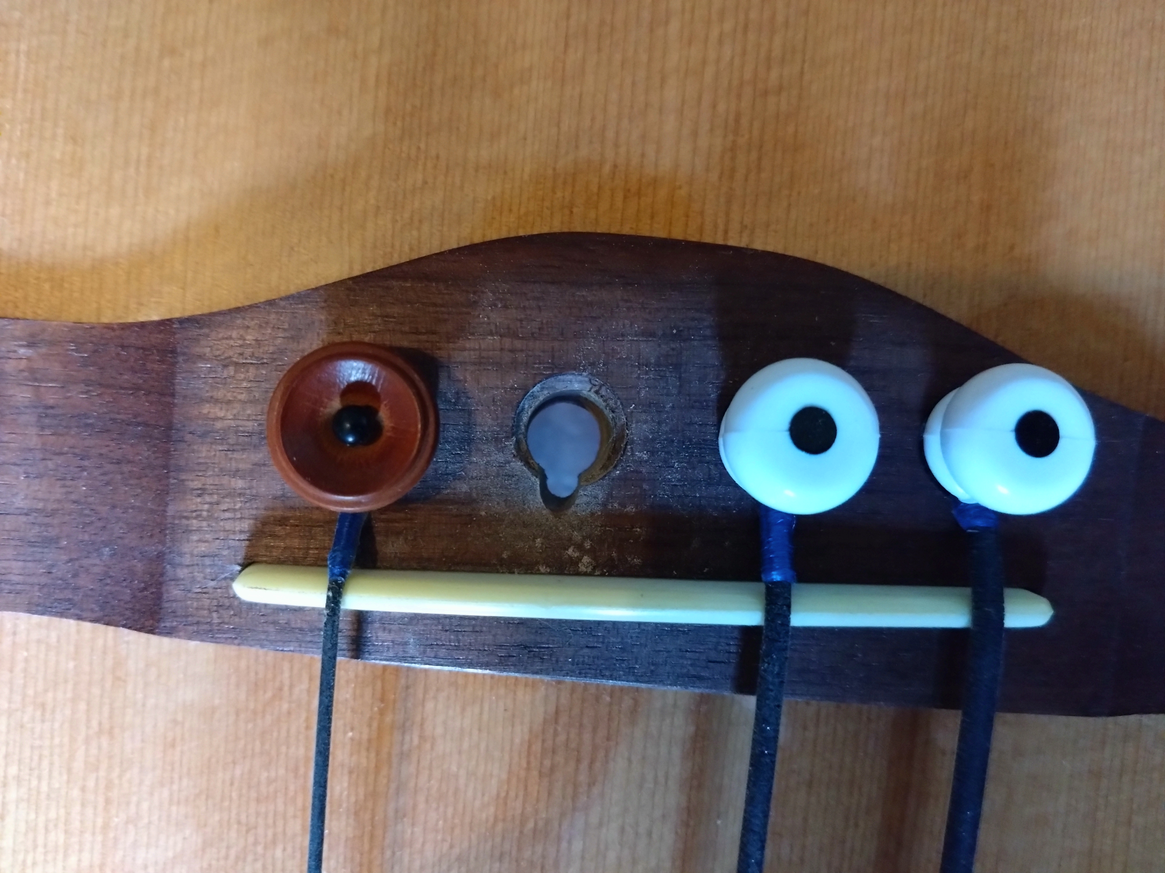 Bridge with pin missing and string channel filed